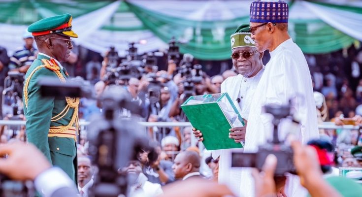 Former president Muhammadu Buhari handing over to President Bola Tinubu