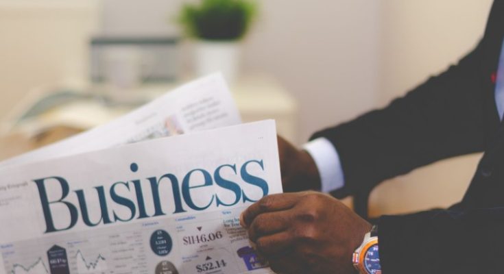 Man holding newspaper on business trading